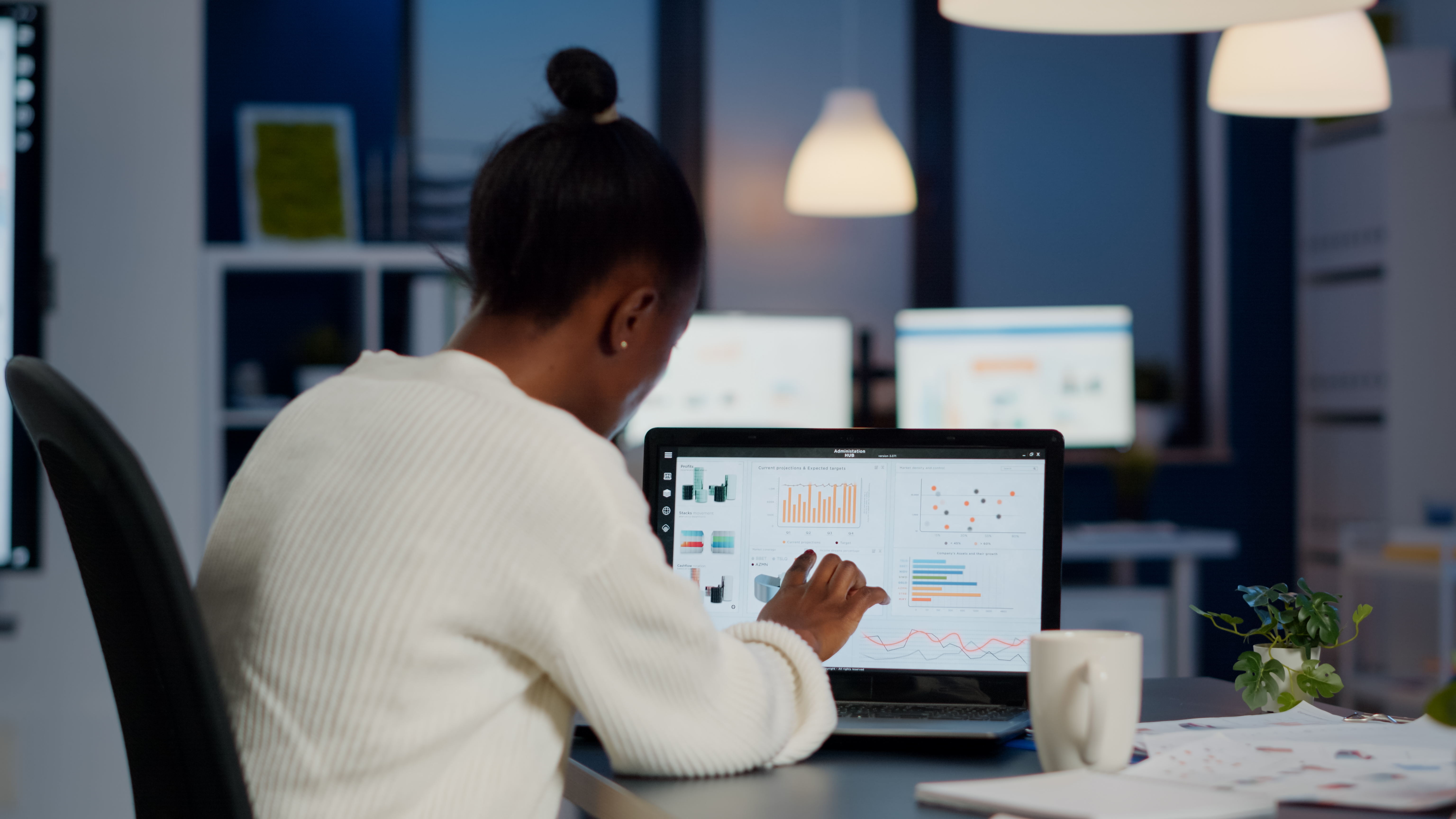 young-woman-manager-checking-business-statistics-financial-reports-laptop-working-start-up-office-late-night